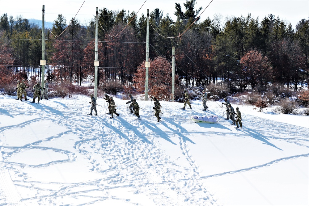 Cold-Weather Operations Course class 21-04 students conduct field training in snowshoes, pulling sleds