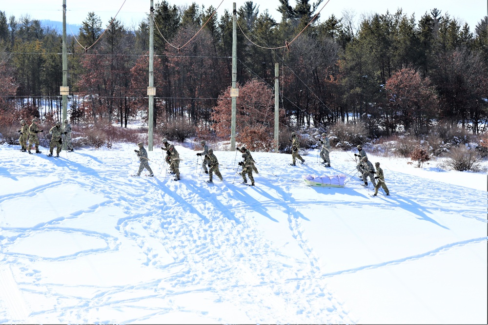 Cold-Weather Operations Course class 21-04 students conduct field training in snowshoes, pulling sleds