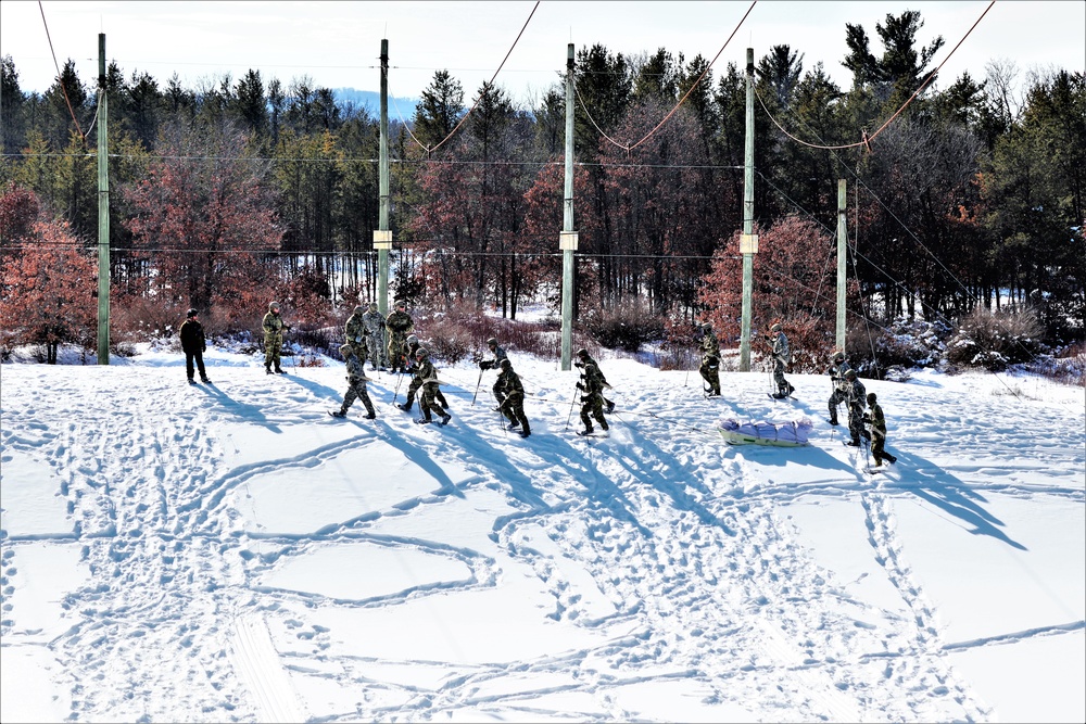 Cold-Weather Operations Course class 21-04 students conduct field training in snowshoes, pulling sleds