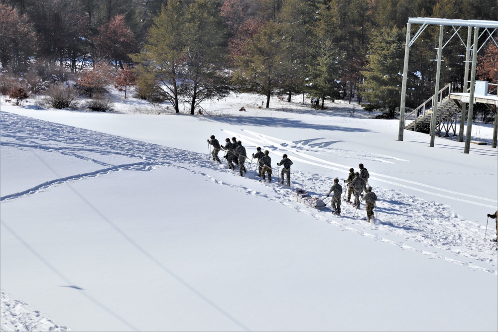 Cold-Weather Operations Course class 21-04 students conduct field training in snowshoes, pulling sleds