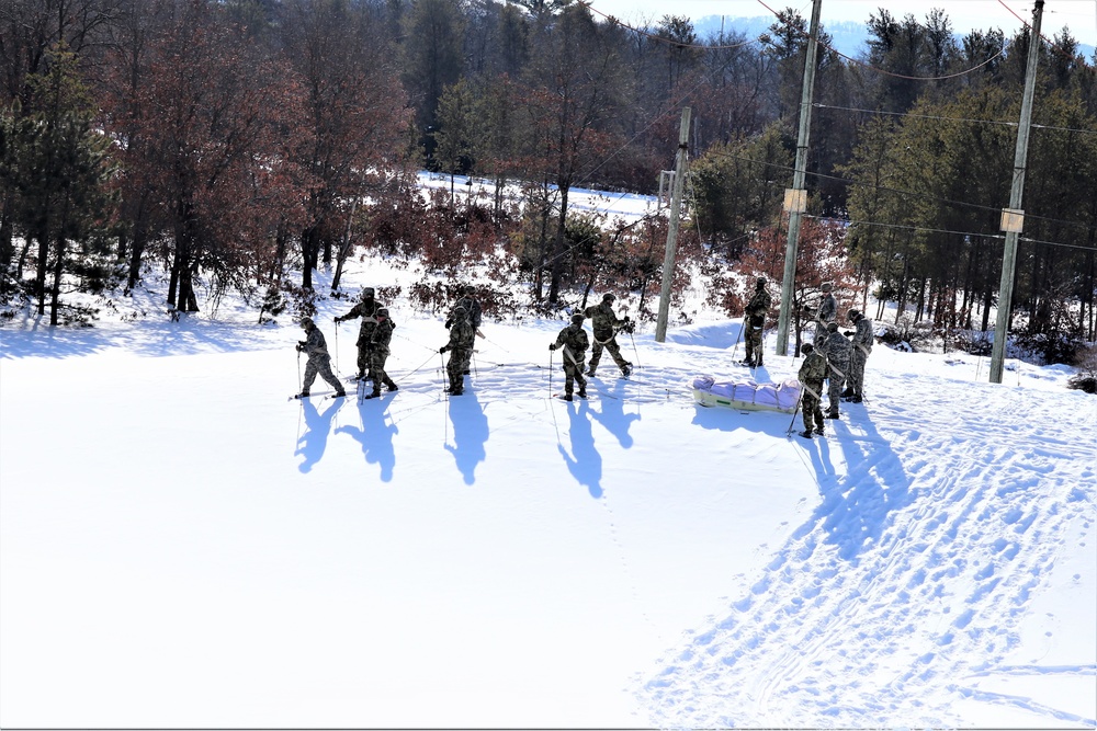 Cold-Weather Operations Course class 21-04 students conduct field training in snowshoes, pulling sleds