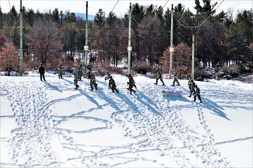 Cold-Weather Operations Course class 21-04 students conduct field training in snowshoes, pulling sleds