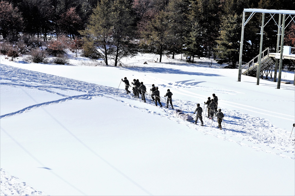 Cold-Weather Operations Course class 21-04 students conduct field training in snowshoes, pulling sleds