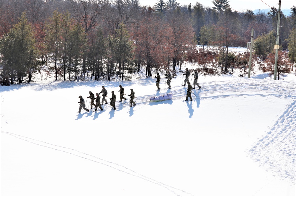 Cold-Weather Operations Course class 21-04 students conduct field training in snowshoes, pulling sleds