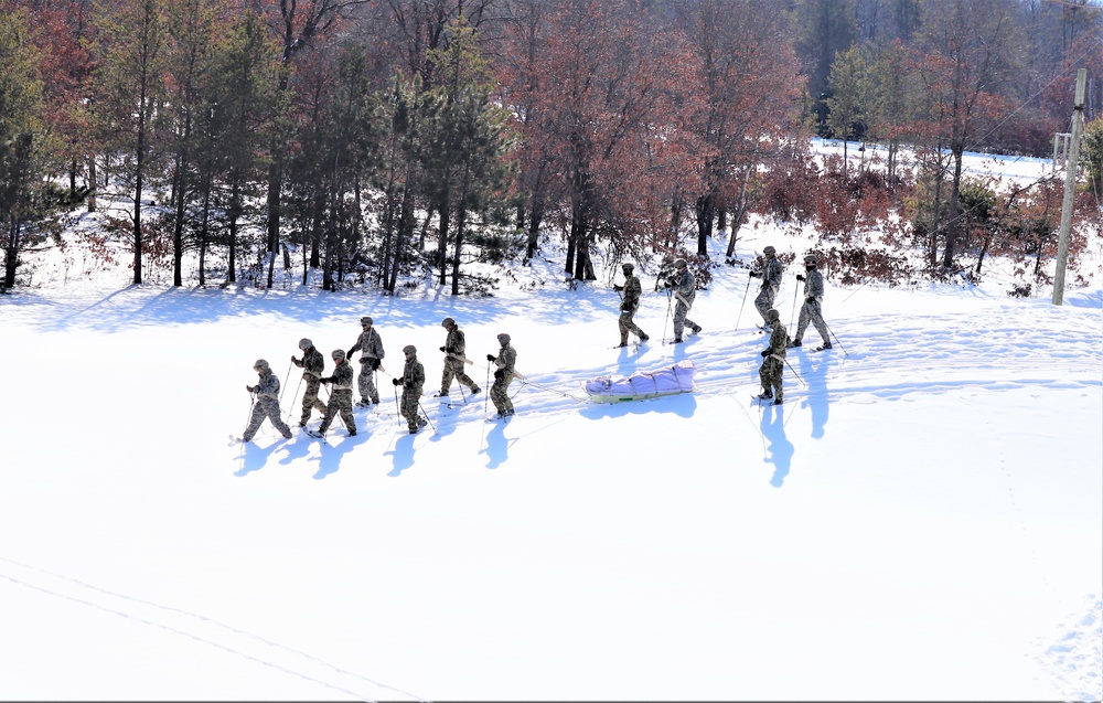 Cold-Weather Operations Course class 21-04 students conduct field training in snowshoes, pulling sleds