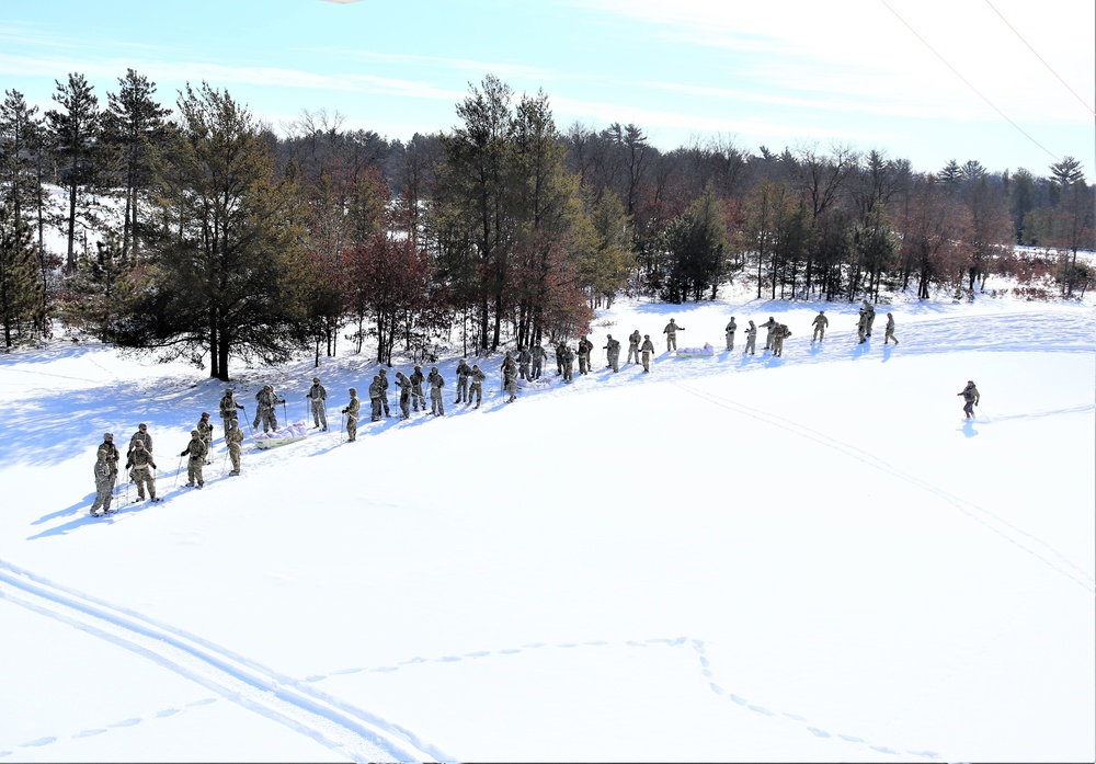 Cold-Weather Operations Course class 21-04 students conduct field training in snowshoes, pulling sleds