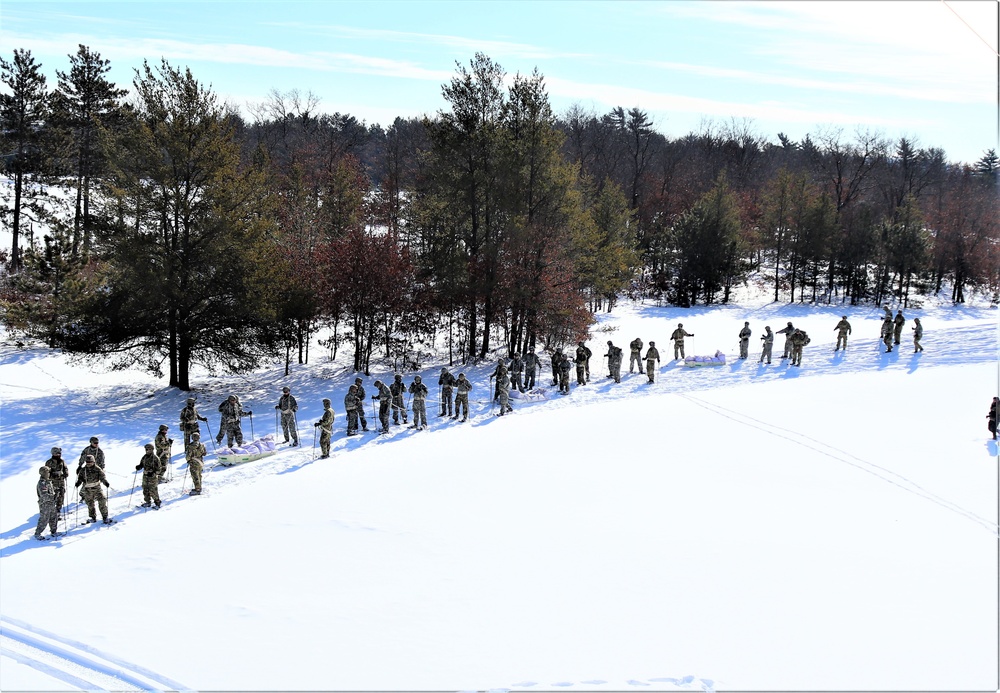 Cold-Weather Operations Course class 21-04 students conduct field training in snowshoes, pulling sleds