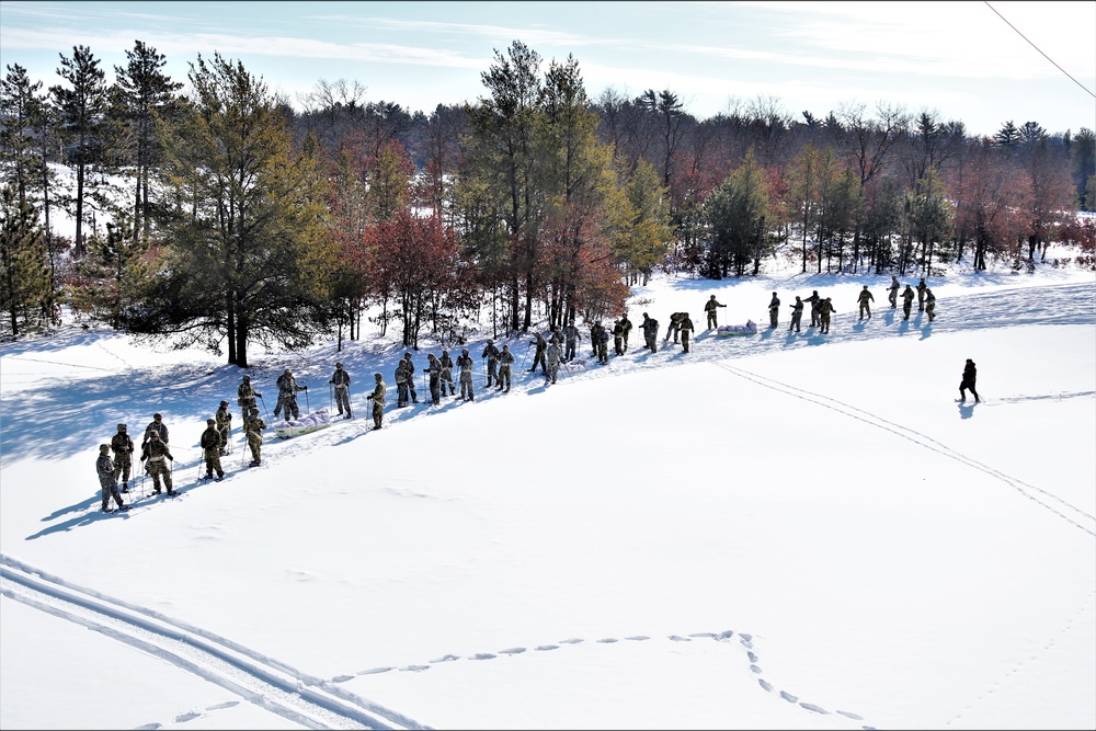 Cold-Weather Operations Course class 21-04 students conduct field training in snowshoes, pulling sleds