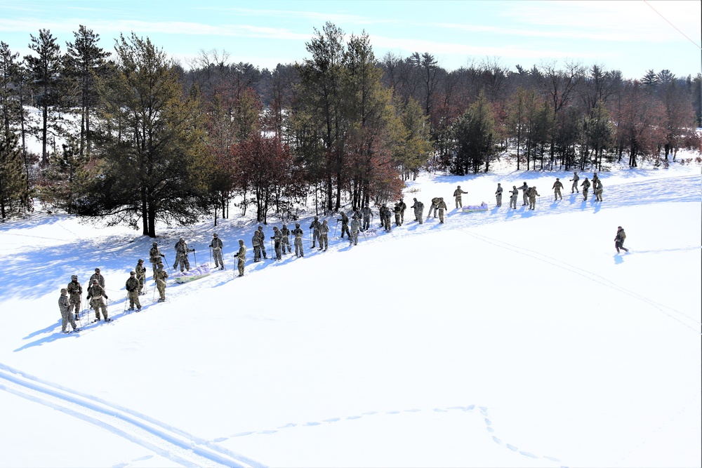 Cold-Weather Operations Course class 21-04 students conduct field training in snowshoes, pulling sleds