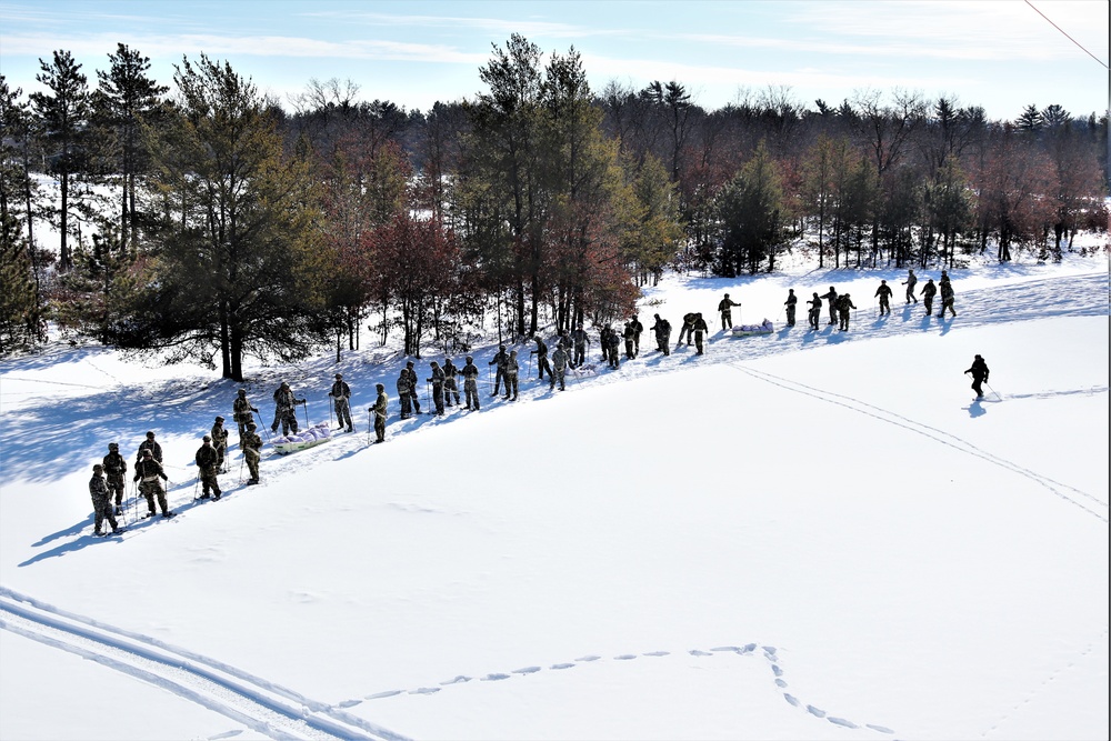 Cold-Weather Operations Course class 21-04 students conduct field training in snowshoes, pulling sleds