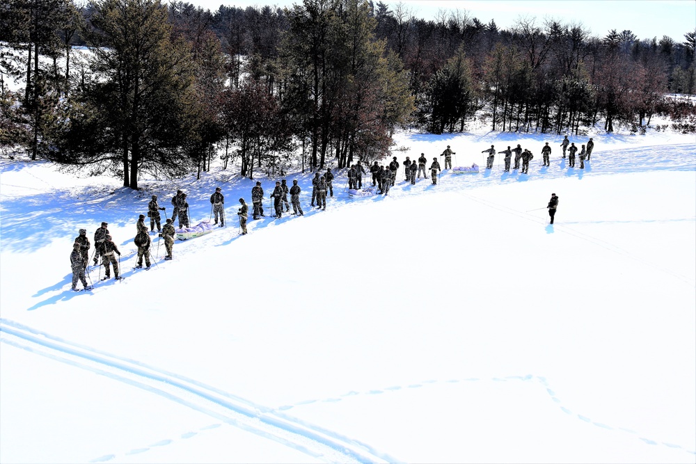 Cold-Weather Operations Course class 21-04 students conduct field training in snowshoes, pulling sleds