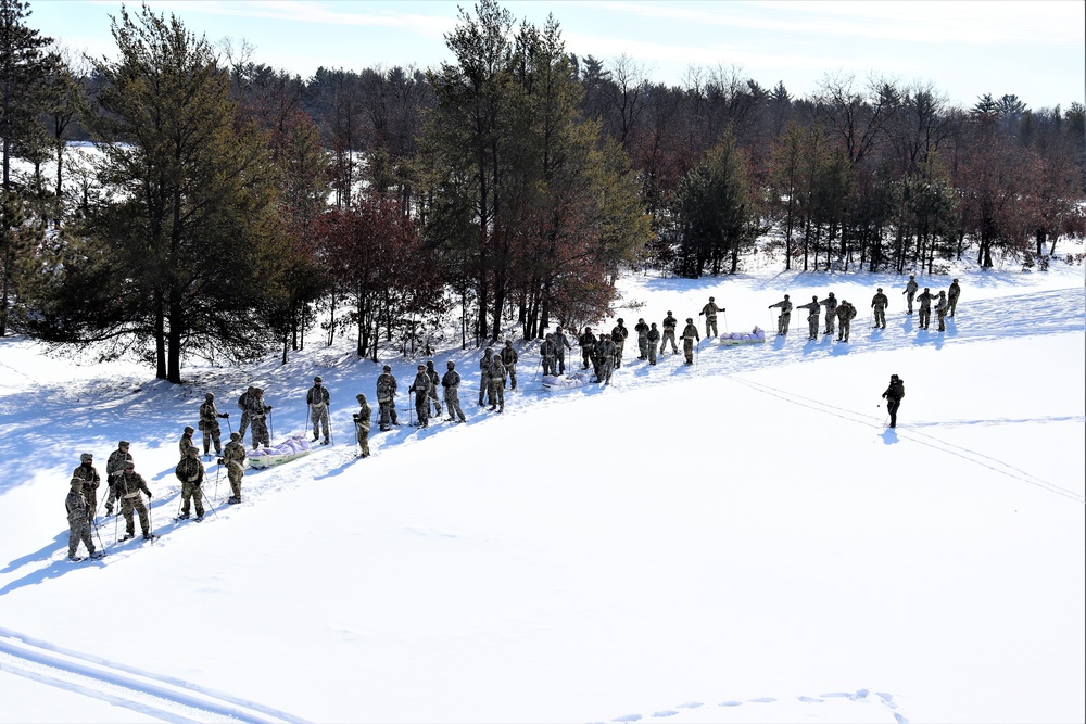 Cold-Weather Operations Course class 21-04 students conduct field training in snowshoes, pulling sleds