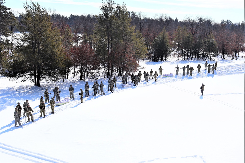 Cold-Weather Operations Course class 21-04 students conduct field training in snowshoes, pulling sleds