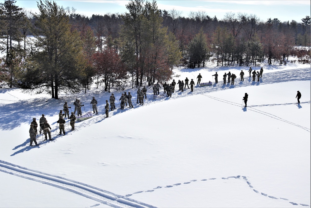 Cold-Weather Operations Course class 21-04 students conduct field training in snowshoes, pulling sleds