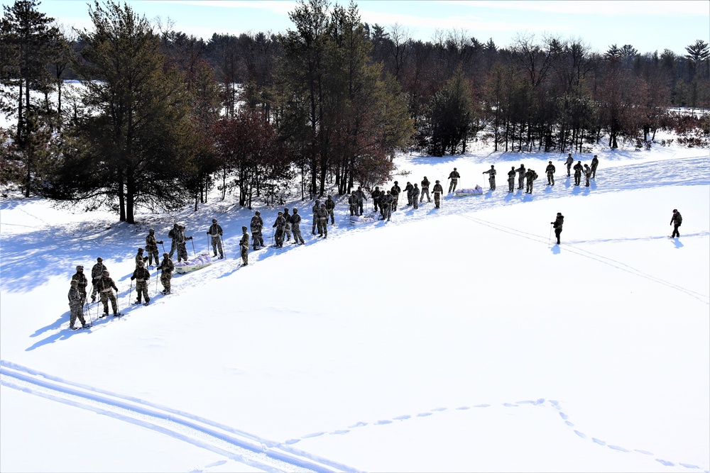 Cold-Weather Operations Course class 21-04 students conduct field training in snowshoes, pulling sleds