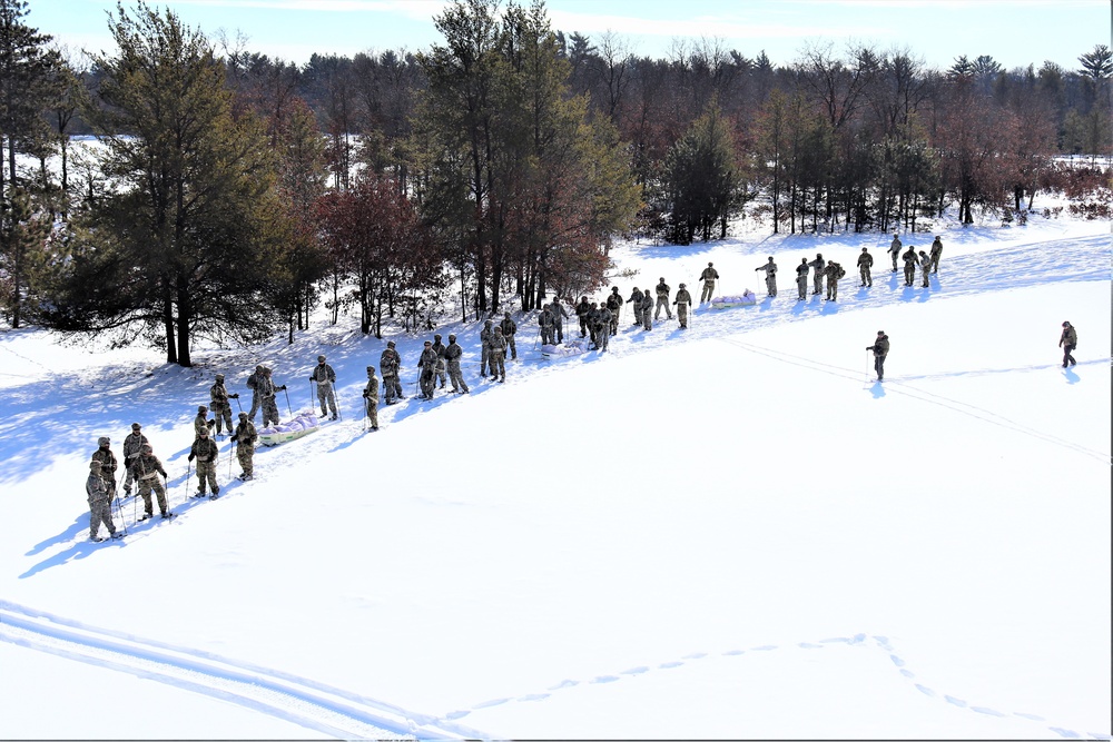 Cold-Weather Operations Course class 21-04 students conduct field training in snowshoes, pulling sleds