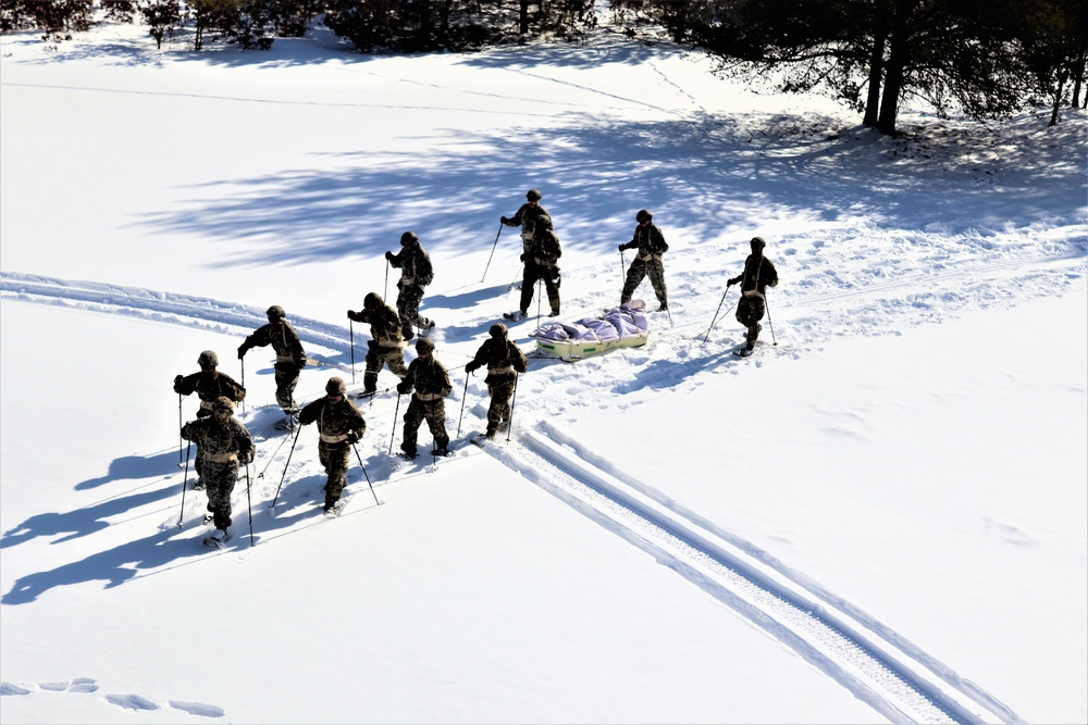 Cold-Weather Operations Course class 21-04 students conduct field training in snowshoes, pulling sleds