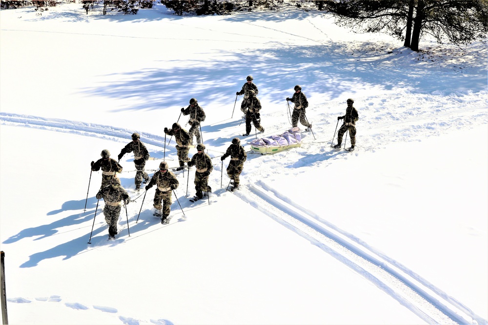 Cold-Weather Operations Course class 21-04 students conduct field training in snowshoes, pulling sleds