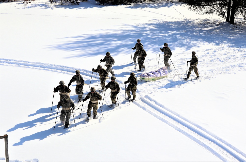 Cold-Weather Operations Course class 21-04 students conduct field training in snowshoes, pulling sleds