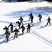 Cold-Weather Operations Course class 21-04 students conduct field training in snowshoes, pulling sleds