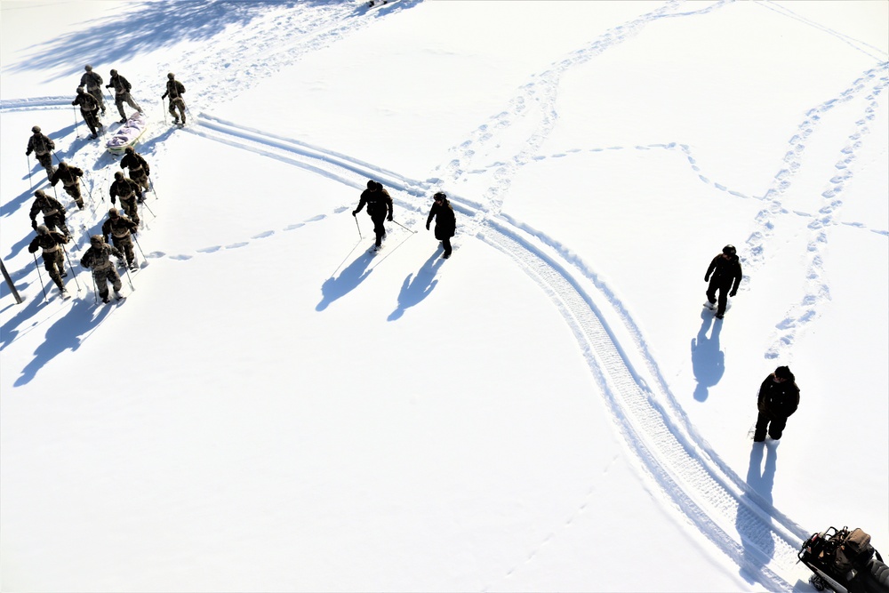 Cold-Weather Operations Course class 21-04 students conduct field training in snowshoes, pulling sleds