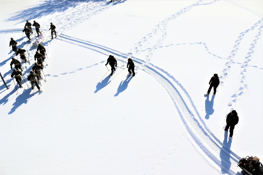 Cold-Weather Operations Course class 21-04 students conduct field training in snowshoes, pulling sleds