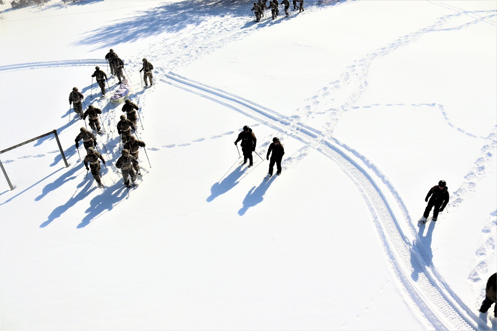 Cold-Weather Operations Course class 21-04 students conduct field training in snowshoes, pulling sleds