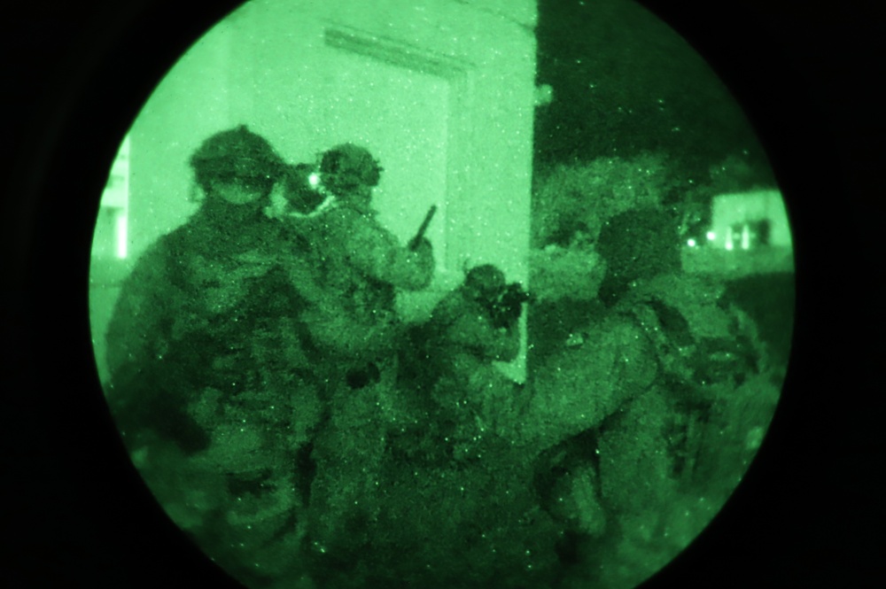 Team of Brazilian Paratroopers prepare to breach corner of building during night operations at JRTC 21-04