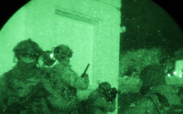 Team of Brazilian Paratroopers prepare to breach corner of building during night operations at JRTC 21-04