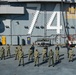 Sailors pose for a photo on the flight deck