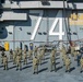 Sailors pose for a photo on the flight deck