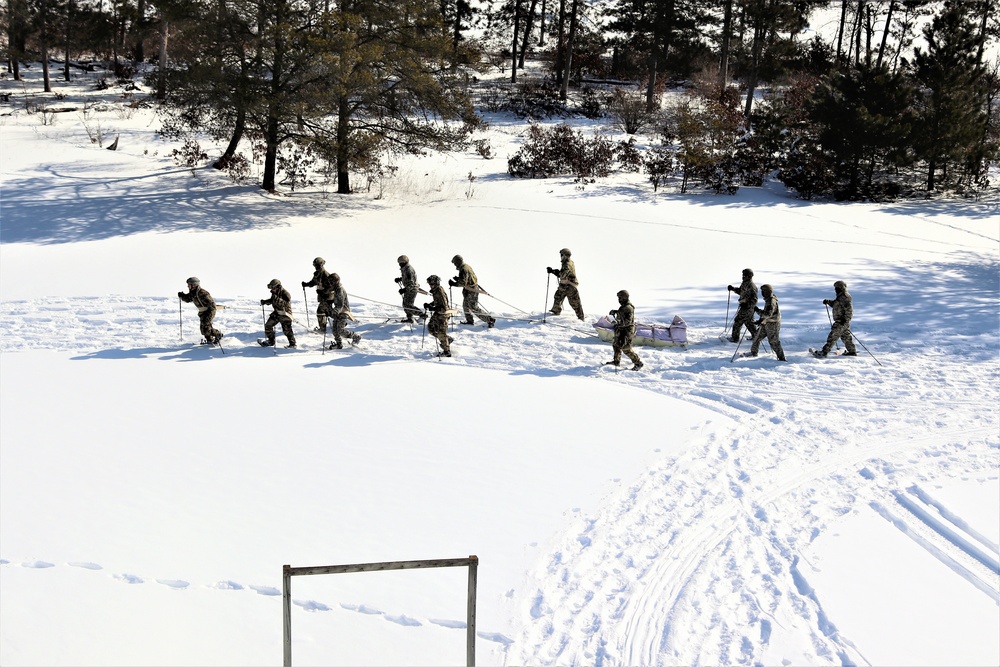 Fort McCoy CWOC class 21-04 students conduct field training in snowshoes, pulling sleds