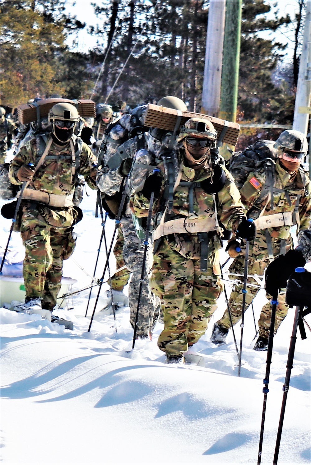 Cold-Weather Operations Course class 21-04 students conduct field training in snowshoes, pulling sleds