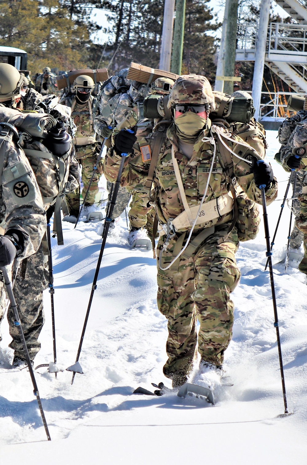 Cold-Weather Operations Course class 21-04 students conduct field training in snowshoes, pulling sleds