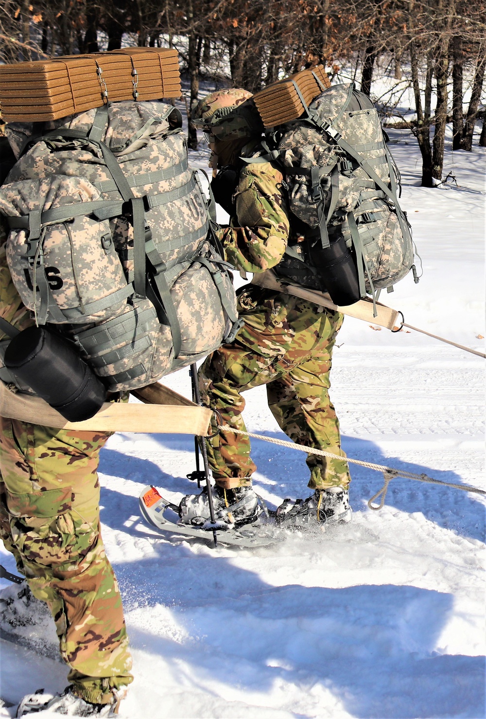 Cold-Weather Operations Course class 21-04 students conduct field training in snowshoes, pulling sleds