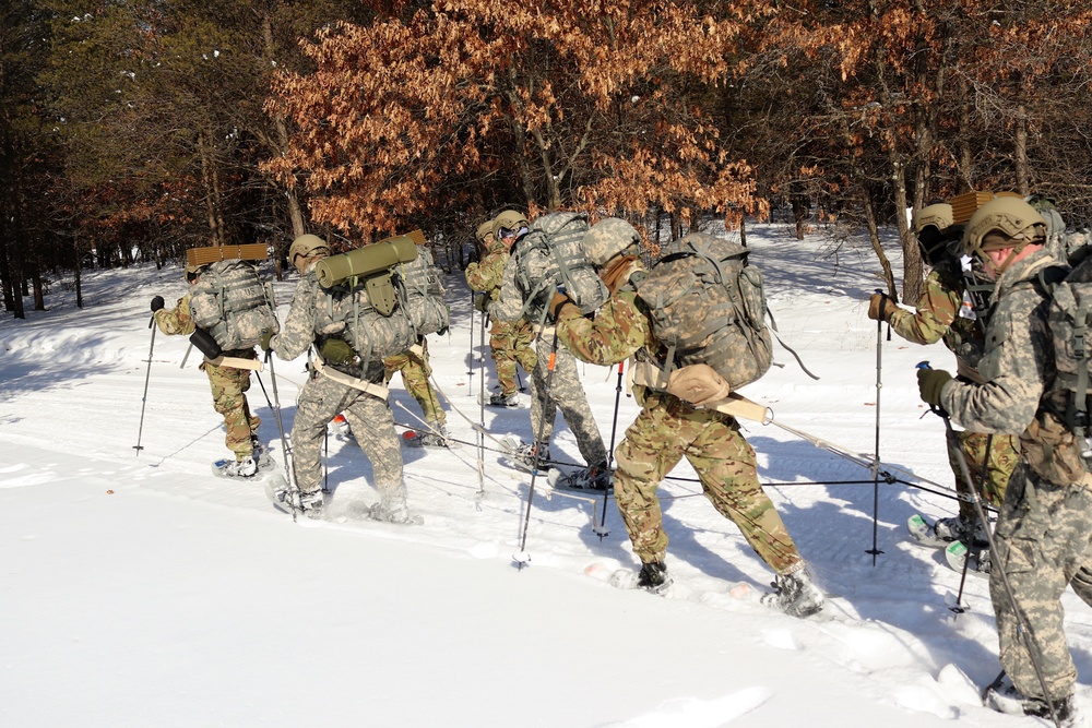 Cold-Weather Operations Course class 21-04 students conduct field training in snowshoes, pulling sleds