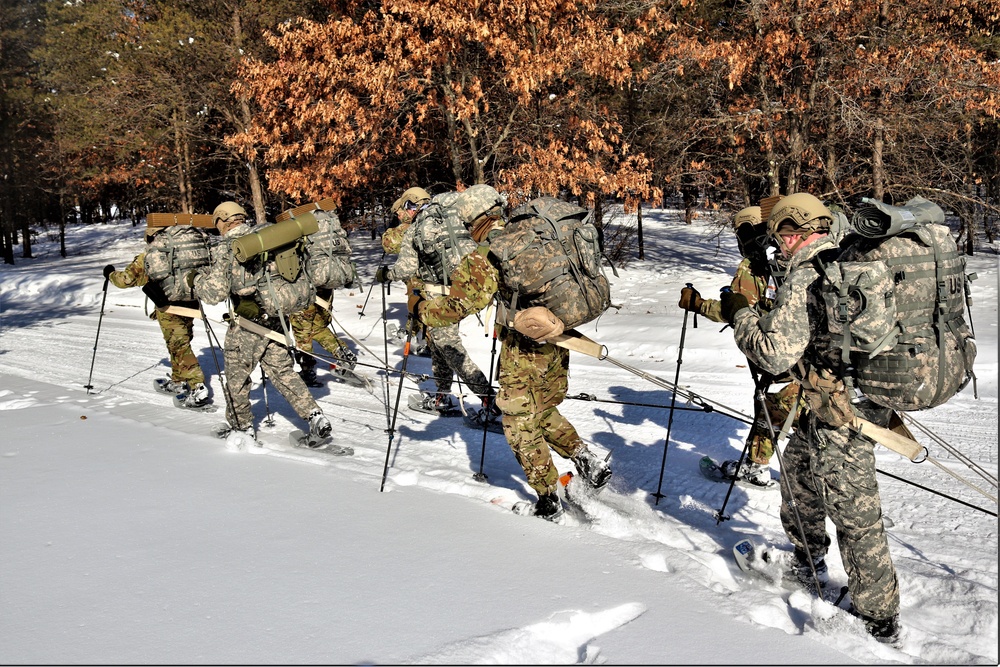 Cold-Weather Operations Course class 21-04 students conduct field training in snowshoes, pulling sleds