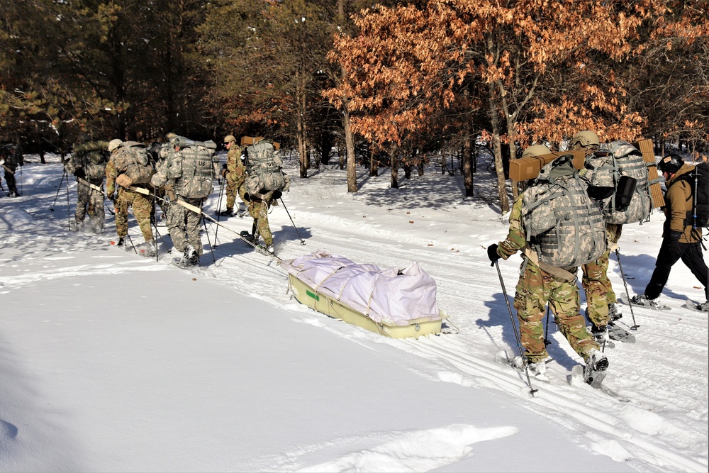Cold-Weather Operations Course class 21-04 students conduct field training in snowshoes, pulling sleds