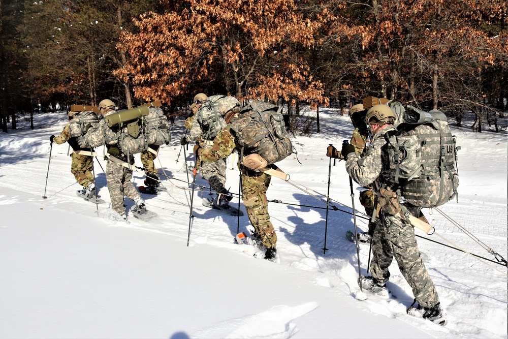 Cold-Weather Operations Course class 21-04 students conduct field training in snowshoes, pulling sleds