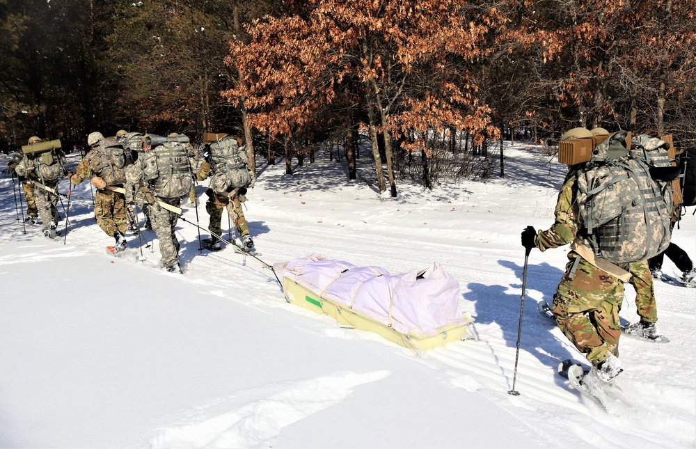 Cold-Weather Operations Course class 21-04 students conduct field training in snowshoes, pulling sleds