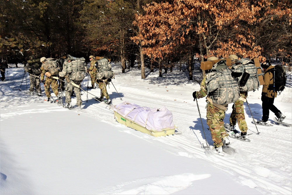 Cold-Weather Operations Course class 21-04 students conduct field training in snowshoes, pulling sleds