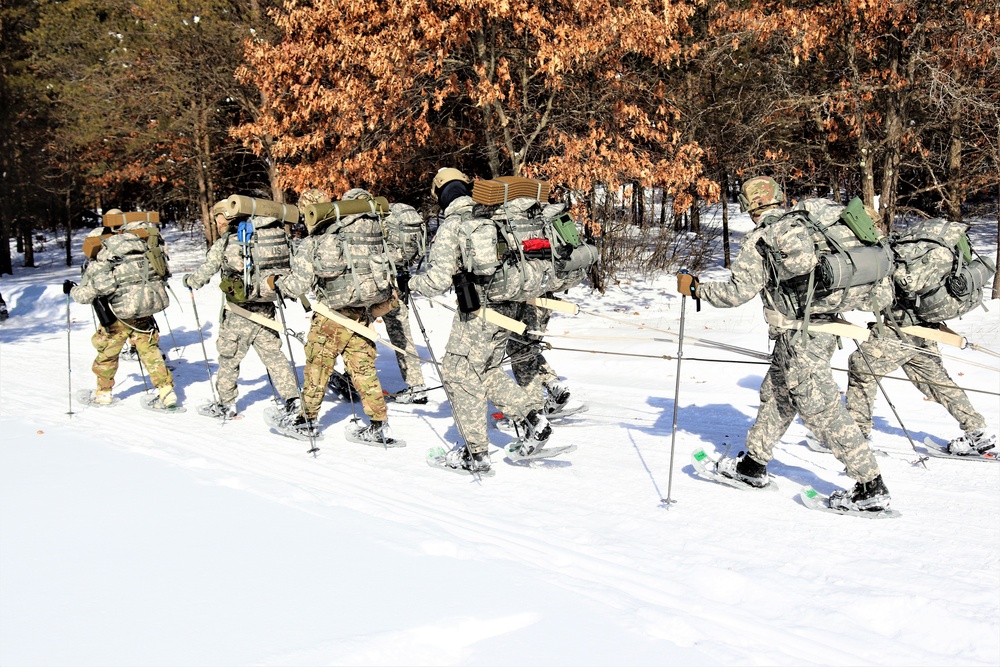Cold-Weather Operations Course class 21-04 students conduct field training in snowshoes, pulling sleds