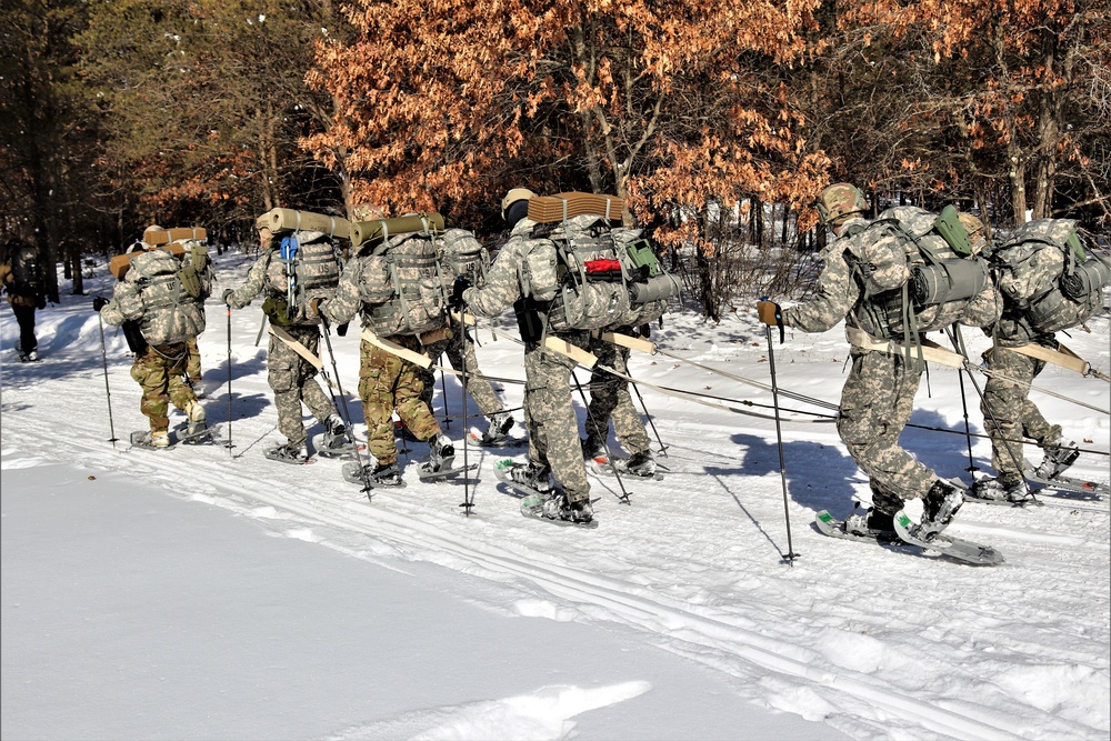 Cold-Weather Operations Course class 21-04 students conduct field training in snowshoes, pulling sleds