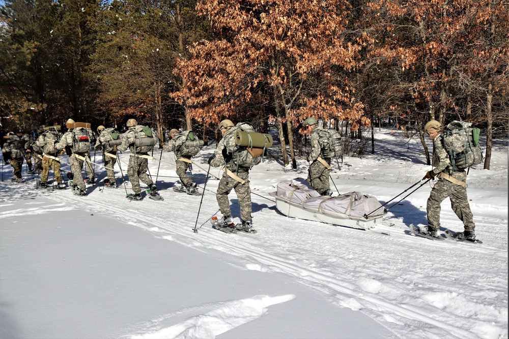 Cold-Weather Operations Course class 21-04 students conduct field training in snowshoes, pulling sleds