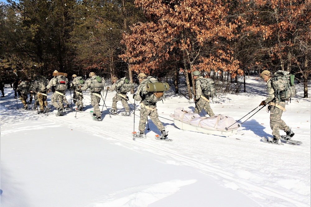 Cold-Weather Operations Course class 21-04 students conduct field training in snowshoes, pulling sleds