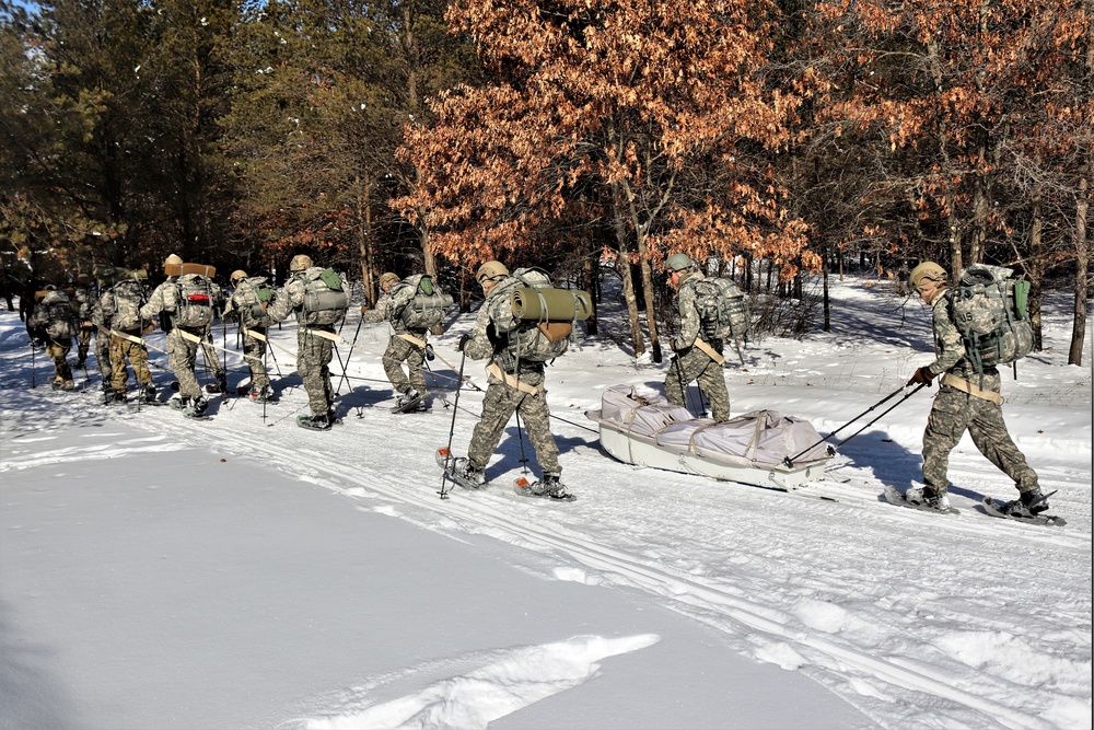 Cold-Weather Operations Course class 21-04 students conduct field training in snowshoes, pulling sleds