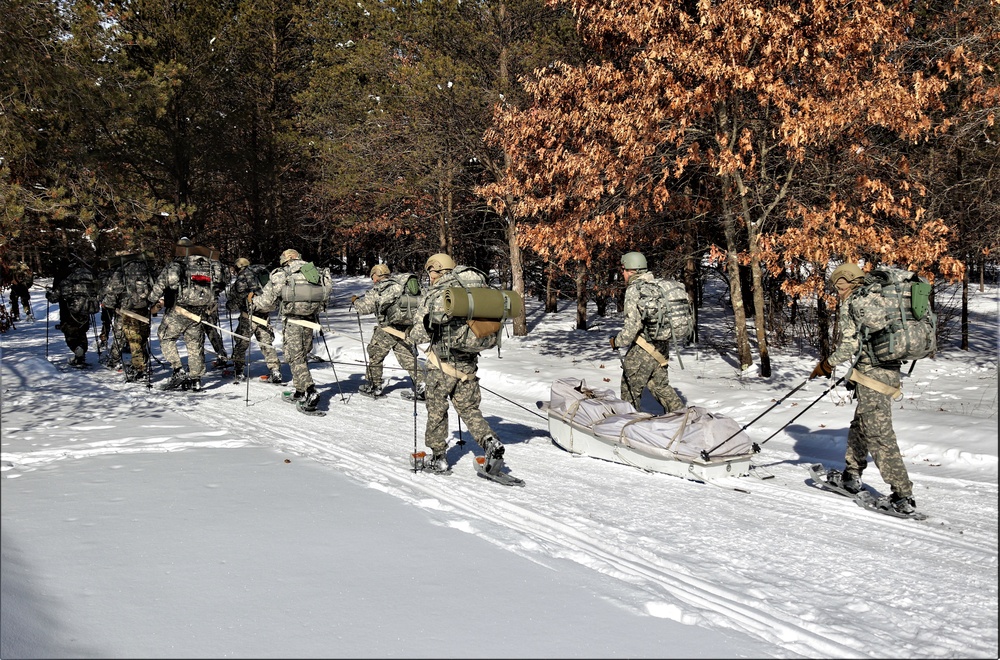 Cold-Weather Operations Course class 21-04 students conduct field training in snowshoes, pulling sleds