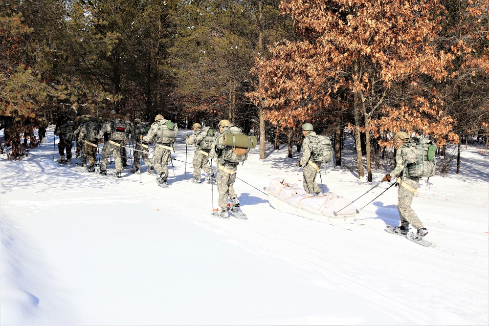 Cold-Weather Operations Course class 21-04 students conduct field training in snowshoes, pulling sleds