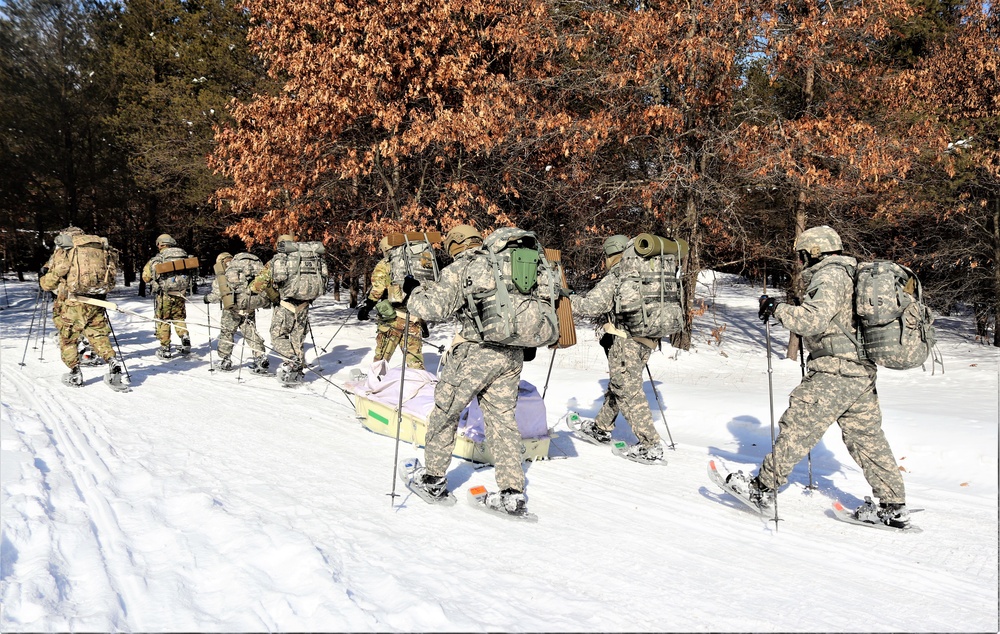 Cold-Weather Operations Course class 21-04 students conduct field training in snowshoes, pulling sleds