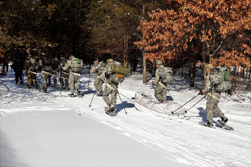 Cold-Weather Operations Course class 21-04 students conduct field training in snowshoes, pulling sleds